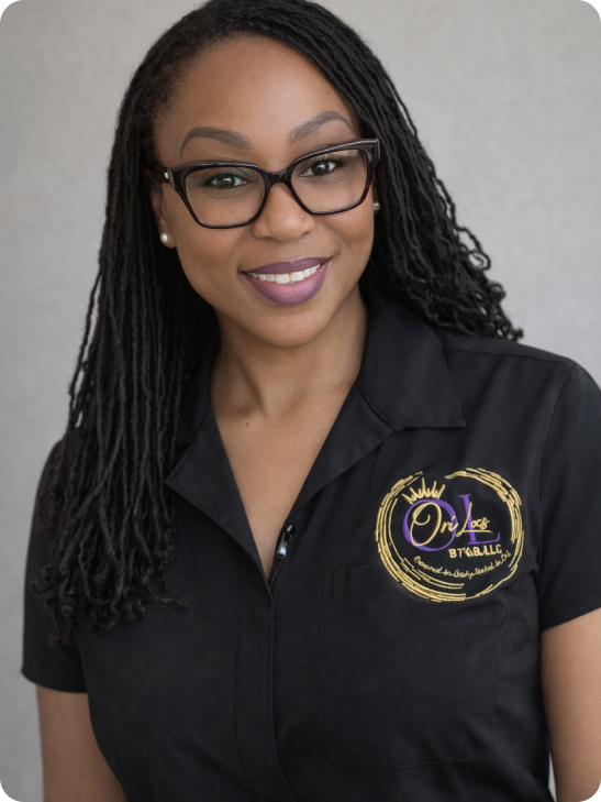 Smiling woman with glasses wearing a black shirt with a logo.